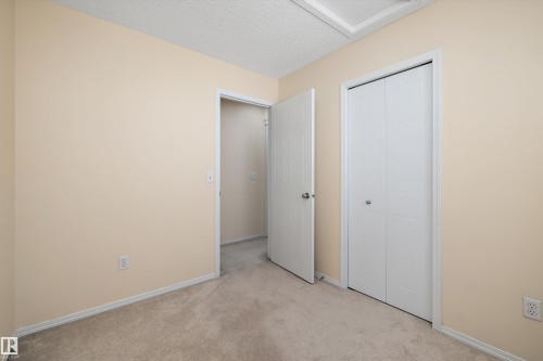 Neutral tone wall paint, textured ceiling, and carpeting - 15016 134 Street, Edmonton, AB 