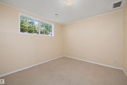 Neutral-toned carpet flooring and walls with white trim - 15016 134 Street, Edmonton, AB 