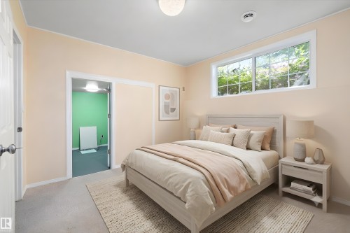 Bedroom featuring a wide window, neutral wall tones, and carpet flooring - 15016 134 Street, Edmonton, AB 