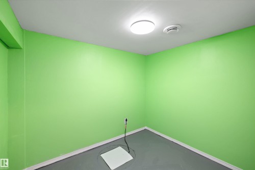 Room with bright green walls, a white ceiling, and gray flooring - 15016 134 Street, Edmonton, AB 
