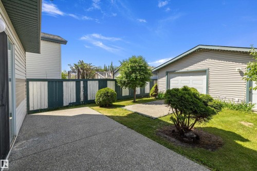 Expansive concrete patio area with a privacy fence - 15016 134 Street, Edmonton, AB 