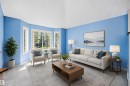 Living area featuring a bay window with multiple panes, providing abundant natural light - 15016 134 Street, Edmonton, AB 