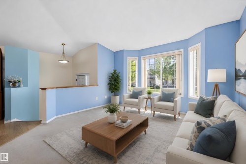 Living area featuring a bay window with multiple panes, light-toned wall finishes, carpeting, and a wood-finish railing - 15016 134 Street, Edmonton, AB 