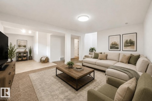 Spacious lower-level living area with recessed lighting, carpet flooring, and a distinct tiled alcove - 8212 148 Street Nw, Edmonton, AB 