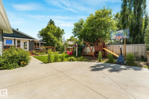 Expansive concrete patio providing direct access to the exterior deck - 8212 148 Street Nw, Edmonton, AB 