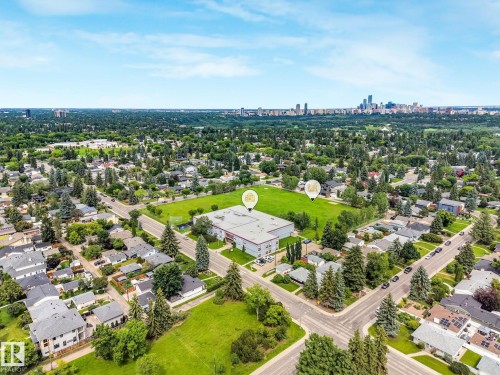 Aerial perspective showcasing a developed neighborhood with mature trees and extensive green spaces - 8212 148 Street Nw, Edmonton, AB 