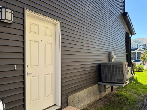 Cream-colored paneled entry door with brushed nickel hardware - 7432 Elmer Road, Edmonton, AB 