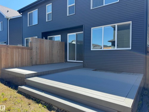 Multi-level composite deck with wide steps and lattice skirting - 7432 Elmer Road, Edmonton, AB 