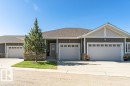 Contemporary exterior featuring horizontal siding, stone accents, and a shingle roof - 15 175 Mcconachie Drive, Edmonton, AB 