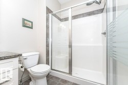 Walk-in shower with frosted glass enclosure - 