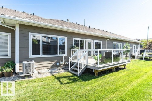 Expansive green lawn bordering a residence with siding exterior - 15 175 Mcconachie Drive, Edmonton, AB 