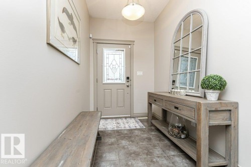 Entryway featuring a decorative front door with leaded glass, tile flooring, and a flush mount ceiling light - 15 175 Mcconachie Drive, Edmonton, AB 