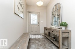 Entryway featuring a decorative front door with leaded glass, tile flooring, and a flush mount ceiling light - 