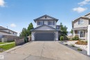 Two-story residence featuring light gray siding with dark gray window shutters and trim - 13406 32A Street, Edmonton, AB 