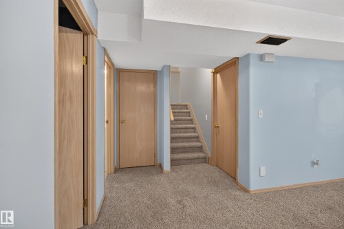 Carpeted lower-level space with light blue painted walls - 13406 32A Street, Edmonton, AB 