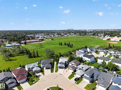Residential neighborhood featuring a cul-de-sac, adjacent green space, and distant city skyline - 13406 32A Street, Edmonton, AB 