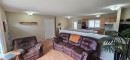 Open-concept living area with wood-finish flooring, neutral wall tones, and recessed lighting - 4734 54A Avenue, Vegreville, AB  - Indoor Photo Showing Living Room 