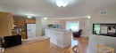 Open-concept living space featuring wood-finish flooring, recessed lighting, and a bay window - 4734 54A Avenue, Vegreville, AB  - Indoor Photo Showing Kitchen 