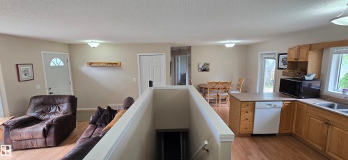 Open concept living area with wood-finish flooring - 4734 54A Avenue, Vegreville, AB - Indoor Photo Showing Kitchen
