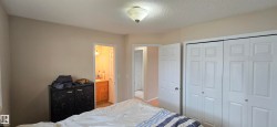 Interior room featuring neutral wall tones, textured ceiling, and a flush-mount ceiling light - 
