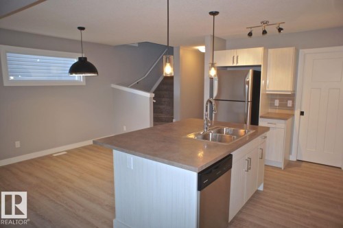 180 Radcliffe Wynd, Fort Saskatchewan, AB - Indoor Photo Showing Kitchen With Double Sink