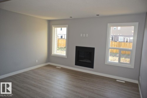 180 Radcliffe Wynd, Fort Saskatchewan, AB - Indoor Photo Showing Living Room With Fireplace
