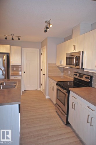 180 Radcliffe Wynd, Fort Saskatchewan, AB - Indoor Photo Showing Kitchen With Stainless Steel Kitchen With Double Sink