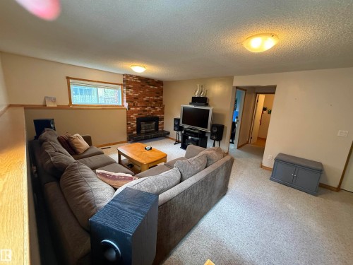 4118 46 Street, Beaumont, AB - Indoor Photo Showing Living Room With Fireplace