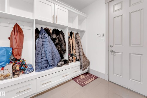 Built-in white cabinetry featuring upper storage, open shelving, and lower drawers - 656 180 Street Sw, Edmonton, AB - Indoor With Storage