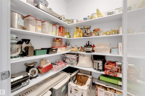 Corner pantry featuring multiple white built-in shelves - 656 180 Street Sw, Edmonton, AB - Indoor With Storage