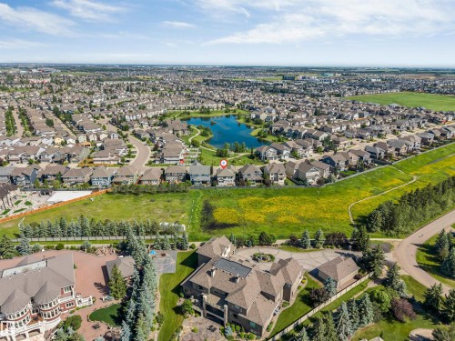 Expansive aerial view showcasing a well-developed residential area with a prominent central pond - 656 180 Street Sw, Edmonton, AB - Outdoor With View