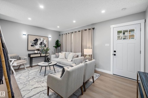 Living area featuring recessed lighting, light-toned walls, and wood-finish flooring - 12912 103 Street, Edmonton, AB 
