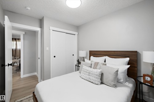 Bedroom featuring light gray walls and wood-finish flooring - 12912 103 Street, Edmonton, AB 
