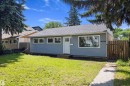 Single-story residence featuring blue horizontal siding and a gray shingle roof - 12912 103 Street, Edmonton, AB 