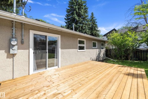 Spacious wooden deck extending from the stucco exterior - 12912 103 Street, Edmonton, AB 