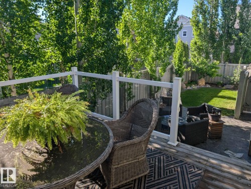 Multi-level outdoor living space featuring a wood-finish deck with glass panel railing - 2327 Frezenberg Avenue, Edmonton, AB 