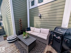 Private patio area with wood-finish decking and horizontal siding - 