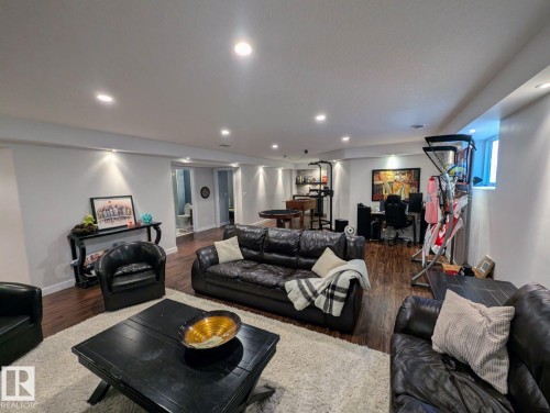 Spacious open-concept lower level featuring recessed lighting and wood-finish flooring - 2327 Frezenberg Avenue, Edmonton, AB 