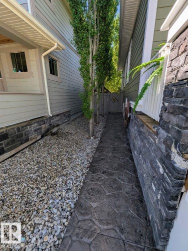 Stamped concrete pathway featuring a decorative garden gate - 2327 Frezenberg Avenue, Edmonton, AB 