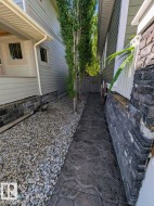 Stamped concrete pathway featuring a decorative garden gate - 