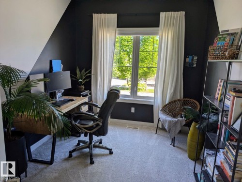 Room featuring light gray carpet flooring and a double-pane window with white trim - 2327 Frezenberg Avenue, Edmonton, AB 