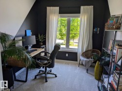 Room featuring light gray carpet flooring and a double-pane window with white trim - 