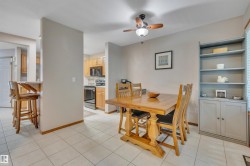 Dining area featuring tile flooring, a ceiling fan with integrated lighting. - 