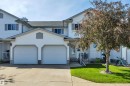 Two-story residence featuring white siding and gray trim - 207-4807 43A Ave, Leduc, AB 
