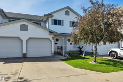 White siding exterior with a one-car garage, concrete driveway, and a front entrance porch - 