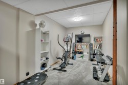 Carpeted room with a drop ceiling and recessed lighting - 