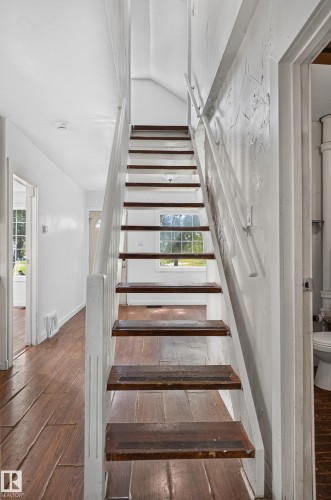 Staircase with wood-finish treads and white risers - 11708 79 Street, Edmonton, AB 