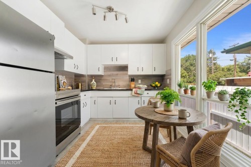 Virtually staged kitchen to help potential buyers envision it as a warm, functional space ready for daily life. - 10602 100 Avenue, Fort Saskatchewan, AB - Indoor Photo Showing Kitchen