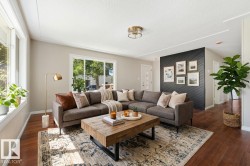 The virtual staging emphasizes the room's excellent flow and spaciousness while making it feel warm and move-in ready. The layout draws the eye naturally from the bright windows and feature wall allowing a buyer to envision this space - 