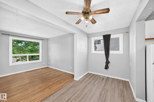 Open-concept room featuring two distinct flooring types: wood-finish and plank-style - 355 Northgate Terrace, Edmonton, AB 